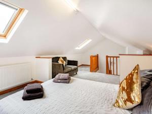a bedroom with a large bed and a couch at 4 Bed in Denbigh oc-62368 in Denbigh