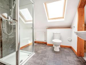 a bathroom with a toilet and a shower and a sink at 4 Bed in Denbigh oc-62368 in Denbigh +28 photos