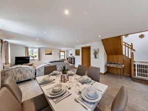 a dining room and living room with a table and chairs at 3 Bed in Arthog oc-77304 in Arthog