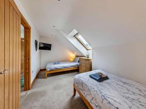 a small bedroom with two beds and a window at 3 Bed in Arthog oc-77304 in Arthog