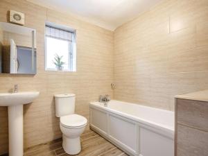 a bathroom with a toilet and a tub and a sink at 3 Bed in Bala oc-88351 in Frongoch +7 photos