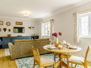 a living room with a table and a couch at 1 Bed in Aberdare oc-82906 in Merthyr Tydfil