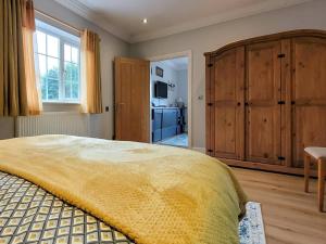 a bedroom with a large bed and a large wooden cabinet at 1 Bed in Aberdare oc-82906 in Merthyr Tydfil