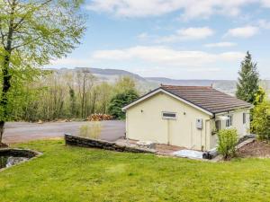 a small white building on the side of a road at 1 Bed in Aberdare oc-82906 in Merthyr Tydfil