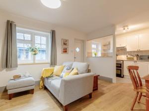 a living room with a couch and a kitchen at 2 Bed in Swansea oc-77978 in Penclawdd