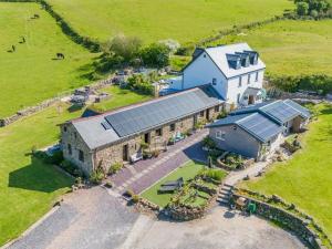 an aerial view of a large house with solar panels on it at 2 Bed in Swansea oc-77978 in Penclawdd