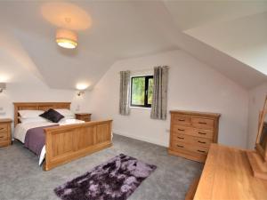 a bedroom with a bed and a window at 4 Bed in Llanrwst oc-66510 in Llanrwst