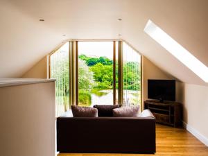 a living room with a couch and a large window at 2 Bed in Narberth oc-36797 in Llawhaden