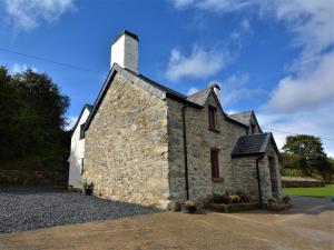 an old stone building with a chimney on top at 4 Bed in Llanrwst oc-66510 in Llanrwst