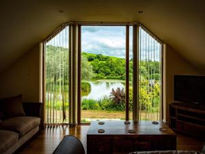 a living room with a large window with a view of a lake at 2 Bed in Narberth oc-36797 in Llawhaden