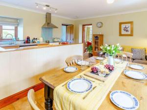 a dining room with a table and a kitchen at 2 Bed in Clynderwen oc-82445 in Clynderwen +25 photos