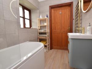 a bathroom with a tub and a toilet and a sink at 2 Bed in Clynderwen oc-82445 in Clynderwen