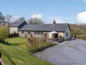 an old stone house with a gravel driveway at 2 Bed in Clynderwen oc-82445 in Clynderwen