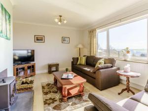 a living room with a couch and a tv at 3 Bed in Clynderwen oc-73936 in Maenclochog