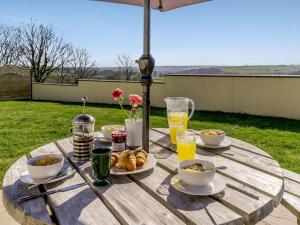 a wooden table with food and drinks on it at 3 Bed in Clynderwen oc-73936 in Maenclochog