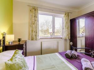 a bedroom with a bed and a window at 3 Bed in Clynderwen oc-73936 in Maenclochog +19 photos