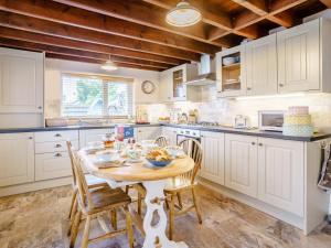 a kitchen with a table and chairs in a kitchen at 3 Bed in Narberth oc-79443 in Narberth
