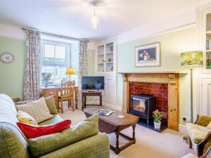a living room with a couch and a fireplace at 3 Bed in Narberth oc-79443 in Narberth
