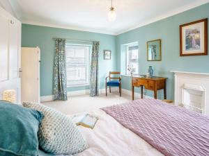 a bedroom with a bed and a desk in it at 3 Bed in Narberth oc-79443 in Narberth