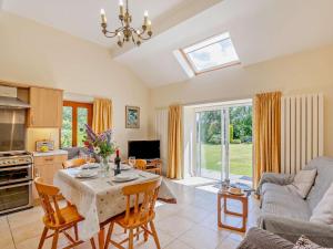 a kitchen and living room with a table and chairs at 2 Bed in Conwy oc-42573 in Llangelynin