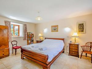 a bedroom with a bed and a desk and a chair at 2 Bed in Conwy oc-42573 in Llangelynin