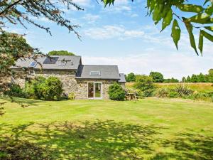 a stone house with a lawn in front of it at 2 Bed in Conwy oc-42573 in Llangelynin
