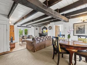 a living room with a table and a couch at 2 Bed in Swansea oc-88216 in Port-Eynon