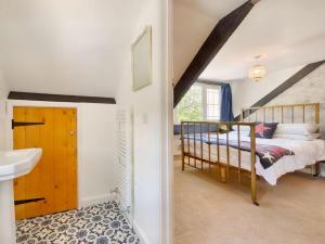 a bedroom with a bed and a sink in a room at 2 Bed in Swansea oc-88216 in Port-Eynon