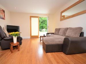 a living room with a couch and a television at 3 Bed in Narberth oc-36798 in Llawhaden