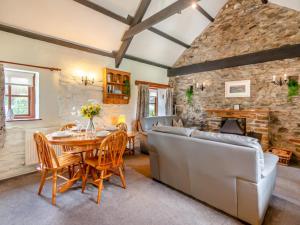 a living room with a table and a couch at 2 Bed in Haverfordwest oc-94123 in Trevine