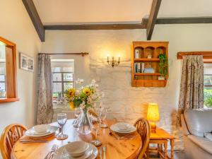 a dining room with a wooden table and chairs at 2 Bed in Haverfordwest oc-94123 in Trevine