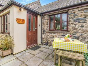 a table with a yellow checkered table cloth on a patio at 2 Bed in Haverfordwest oc-94123 in Trevine +11 photos