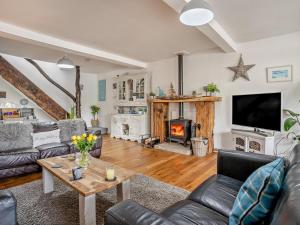 a living room with a couch and a fireplace at 2 Bed in Swansea oc-78845 in Ilston