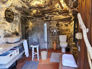 a stone bathroom with a toilet and a sink at Cardenha das Formiguinhas in Monção +94 photos