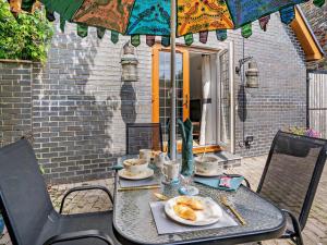 a table with a plate of food and an umbrella at 2 Bed in Swansea oc-95129 in Penclawdd +19 photos