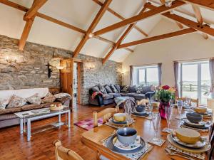 a living room with a couch and a table at 4 Bed in Llanrhystud oc-92072 in Llanrhystyd