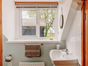 a bathroom with a sink and a window at 4 Bed in Llanrhystud oc-92072 in Llanrhystyd +28 photos