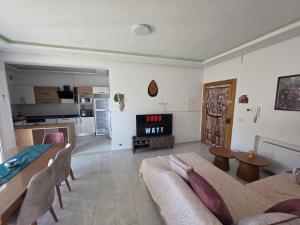 a living room with a couch and a table at Primavera Marmara Hamam sousse in Hammam Sousse