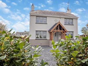 a large white house with a roof at 3 Bed in Pwllheli oc-95040 in Morfa Nefyn