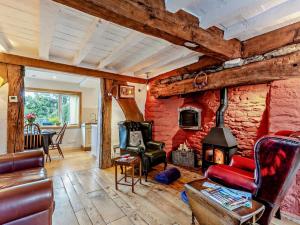 a living room with a stone wall with a fireplace at 2 Bed in Craven Arms oc-83166 in Clun
