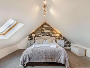 a bedroom with a large bed in a attic at 4 Bed in Amlwch oc-90258 in Llanfechell
