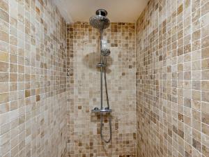 a shower in a tiled bathroom with a shower head at 4 Bed in Amlwch oc-90258 in Llanfechell +18 photos