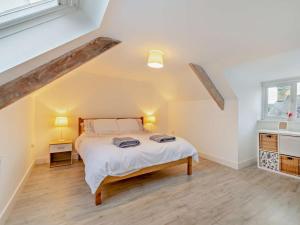 a bedroom with a large bed in a attic at 4 Bed in Cardigan oc-94137 in Aberporth
