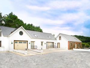 a large white house with a driveway at 3 Bed in Narberth oc-36799 in Llawhaden