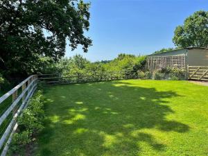 a yard with a fence and green grass at 1 Bed in Presteigne oc-78351 in Kinsham