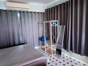a bedroom with a bed and a cage in front of a window at ฮิมแกนแฟมิลี่เฮ้าส์ in Ban Pong (2) +36 photos