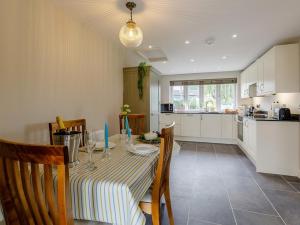 a kitchen and dining room with a table and chairs at 1 Bed in Presteigne oc-78351 in Kinsham