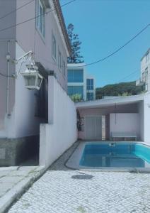 a swimming pool in front of a building at Gama House Shared Appartment in Lisbon