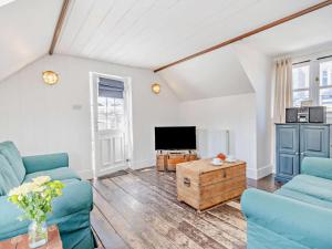 a living room with two blue couches and a tv at 1 Bed in New Quay oc-45927 in New Quay