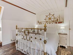 a bedroom with a large white bed with a wooden floor at 1 Bed in New Quay oc-45927 in New Quay